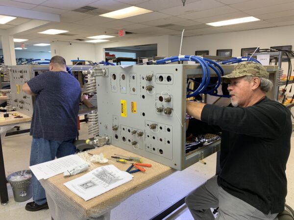 Men working on Cabinets and Racks Assembly.